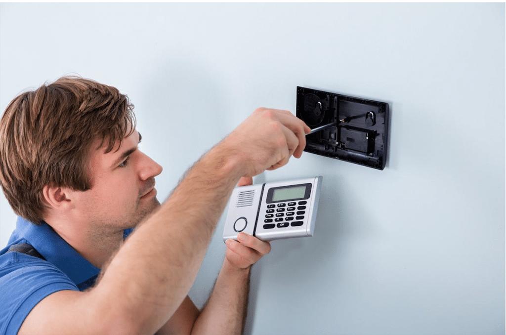 Home alarm system with keypad being installed