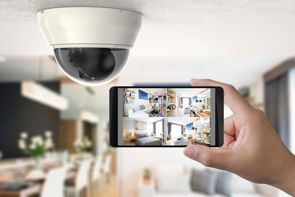 Residential Security Camera and a phone monitoring different camera angles of the residence